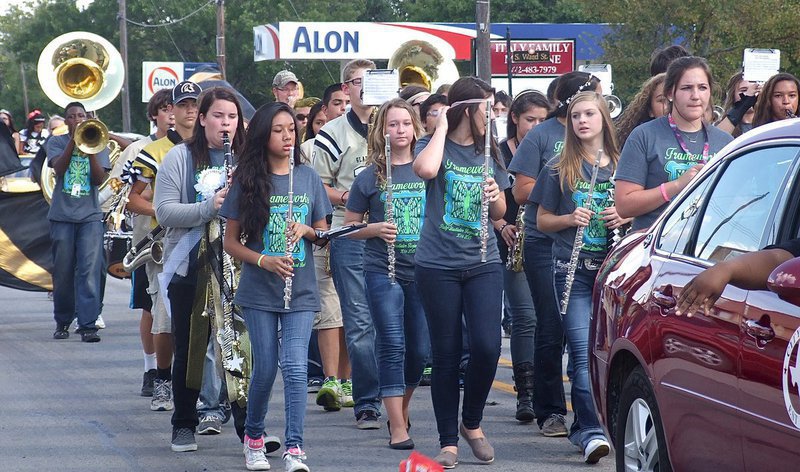 Image: The Gladiator Regiment Marching Band leads the parade thru downtown Italy.