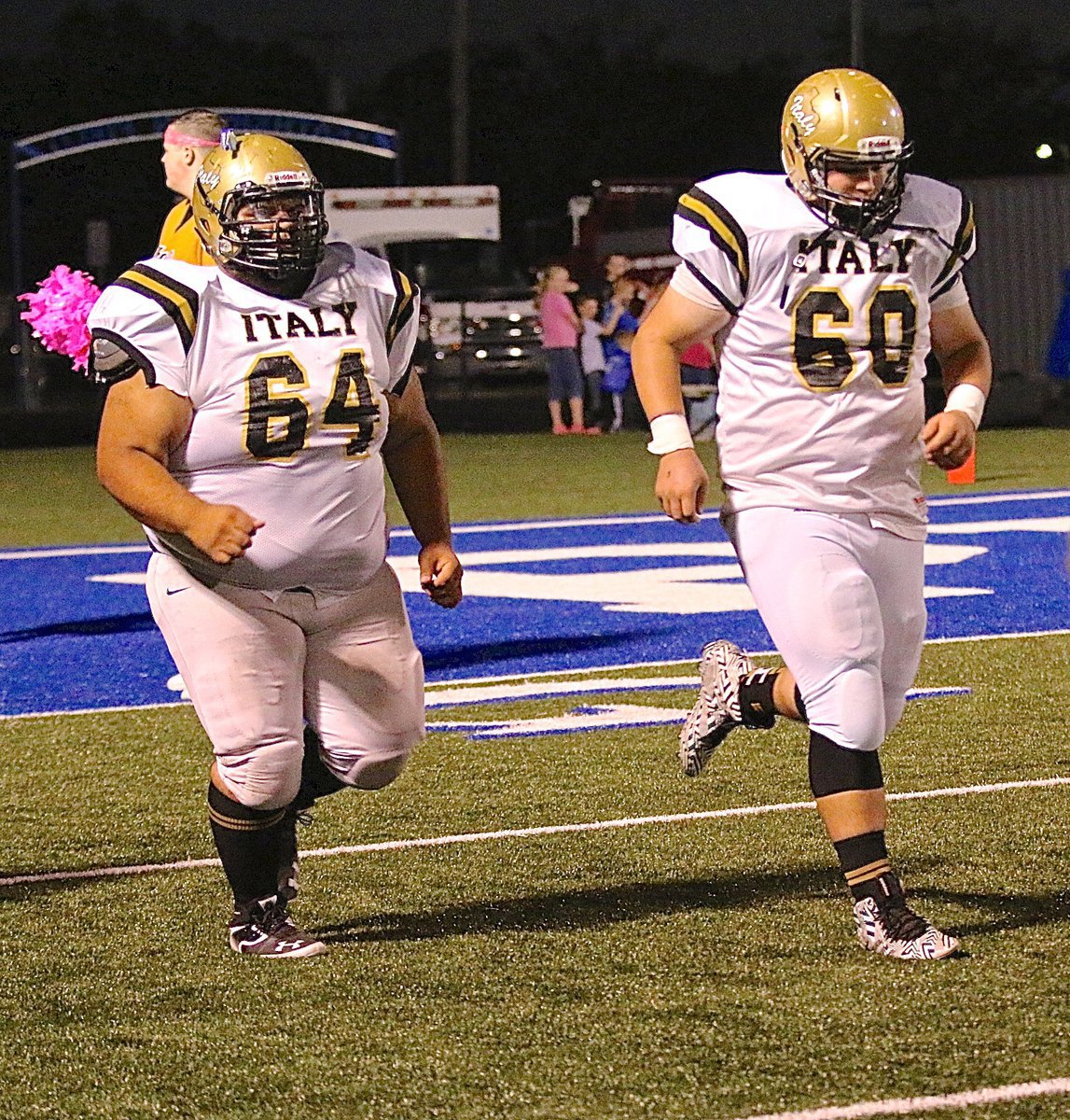 Image: Gladiators Ty Fernandez(64) and John Byers(60) take the field together and block next to each other along Italy’s offensive line.