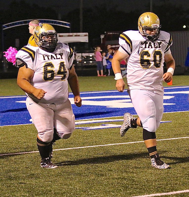Image: Gladiators Ty Fernandez(64) and John Byers(60) take the field together and block next to each other along Italy’s offensive line.