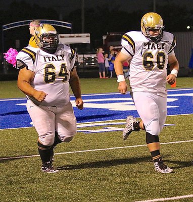 Image: Gladiators Ty Fernandez(64) and John Byers(60) take the field together and block next to each other along Italy’s offensive line.