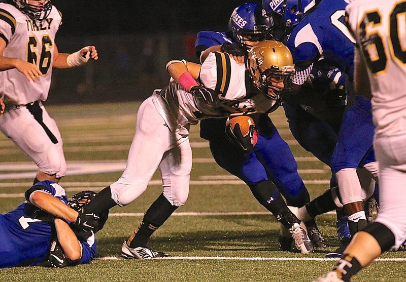 Image: Gladiator receiver Ryan Connor(7) is finally wrapped up by Pirate tacklers.