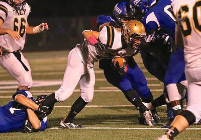 Image: Gladiator receiver Ryan Connor(7) is finally wrapped up by Pirate tacklers.