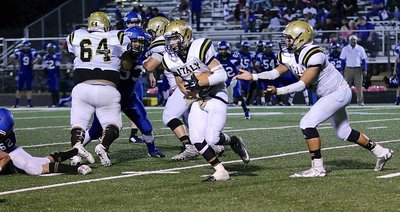 Image: Ryan Connor(7) takes the handoff from Joe Celis(8) as Ty Fernandez(64) and John Byers(60) double-team a Pirate defender.