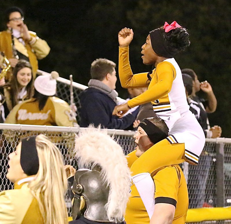 Image: Italy cheerleader K’Breona Davis cheers on the Gladiators with a little help from Zac Mercer.