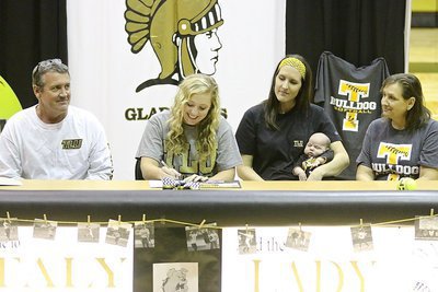 Image: Father and Italy ISD school board member Russ Lewis, sister Megann Lewis Harlow and her new son Renndon James Harlow and mother Kelly Lewis look on as Jaclynn Lewis begins signing her commitment letter to play softball for Texas Lutheran University.