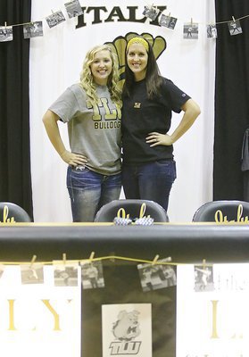 Image: Jaclynn Lewis with her big sister Megann Lewis Harlow during the commitment ceremony inside Italy Gladiator Coliseum. Between them, these fast pitch siblings will have taking the mound in Italy for a combined total of 8 years on varsity.