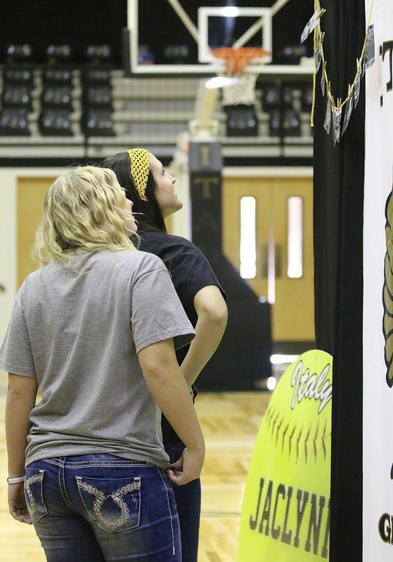 Image: Jaclynn and Megann check out photos of Jaclynn and her team in action over the past three seasons.