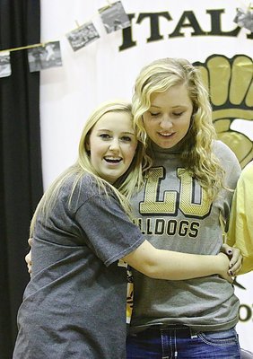 Image: Italy Lady Gladiator teammate Kelsey Nelson gives good ole’ Jac-Attack a congratulatory hug for making her dream come true to play college level softball.