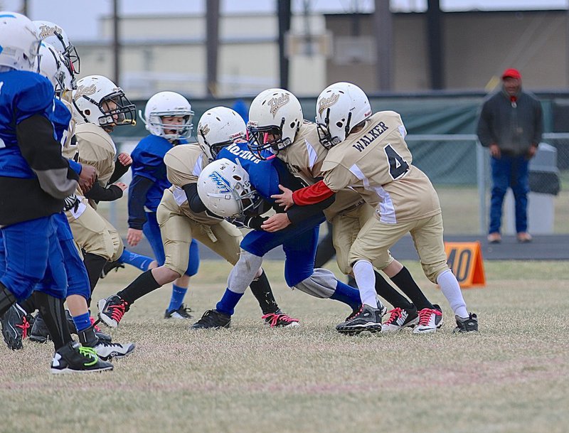 Image: B-team Gladiator defenders Chance Shaffer(6), Gabe Martinez(5), Taylor Sparks(3) and Preston Walker(4) converge on Blooming Grove’s top Lion.