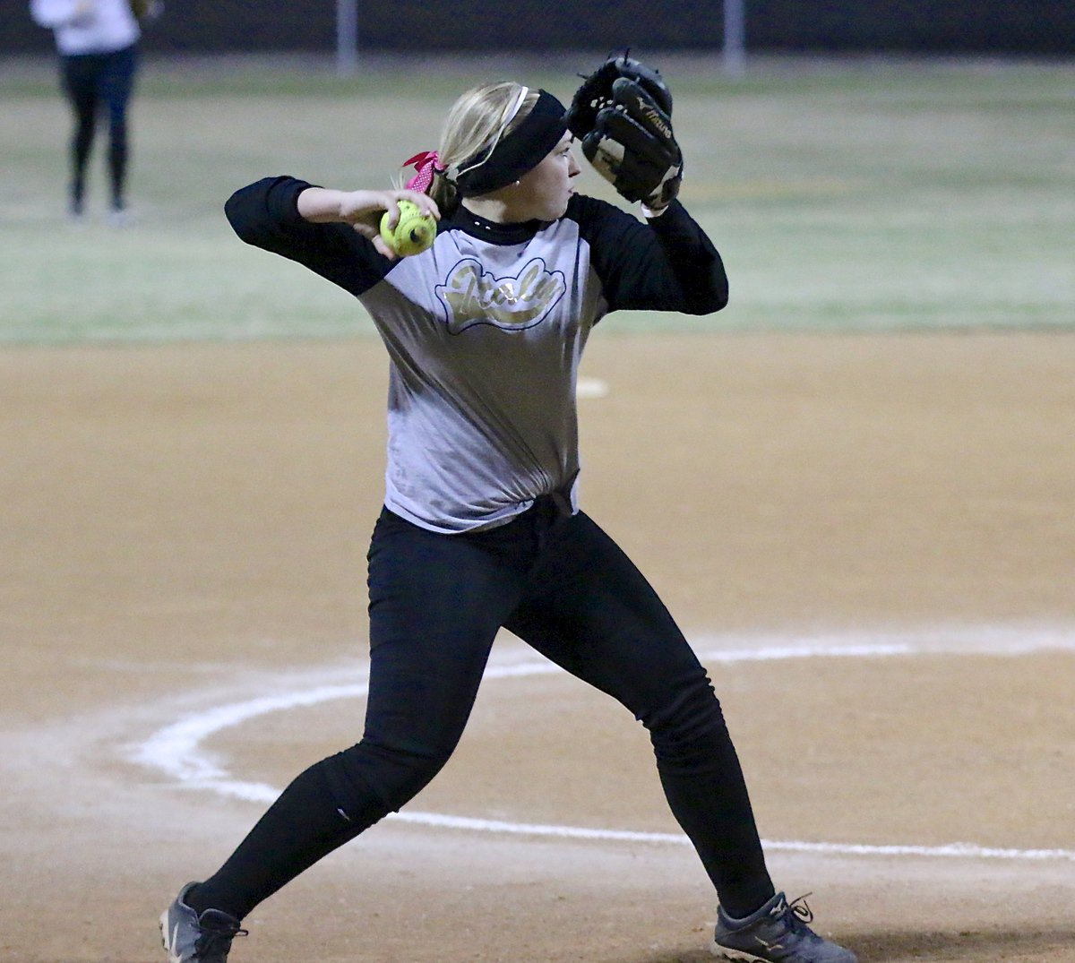 Image: Jaclynn Lewis covers a grounder back to the mound and then throws to first-base for the out, stranding two South Grand Prairie base runners in the bottom of the fourth-inning.
