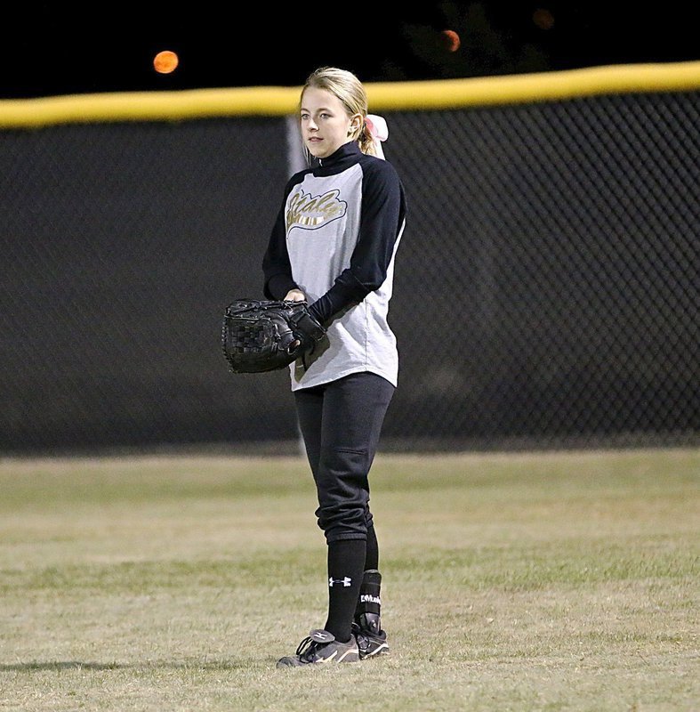 Image: Right fielder Britney Chambers pulls her glove on tight with Italy competing for the tournament championship.
