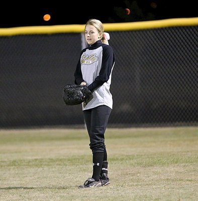 Image: Right fielder Britney Chambers pulls her glove on tight with Italy competing for the tournament championship.