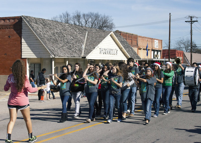 Image: Drum major Vanessa Cantu sets the pace while walking backwards for the Gladiator Regiment Marching Band.