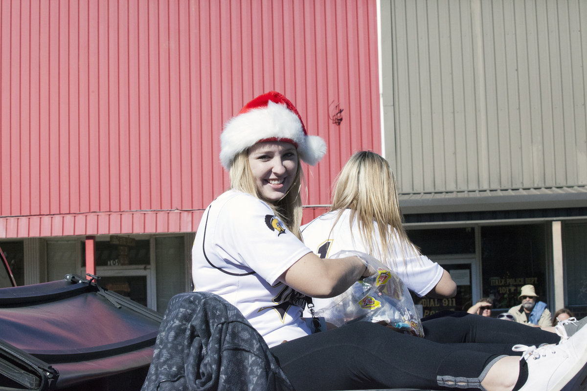 Image: Italy Lady Gladiator softball pitcher Jaclynn Lewis(15) and senior teammate Bailey Eubank(1) are among the most feared candy tossers along the parade route.