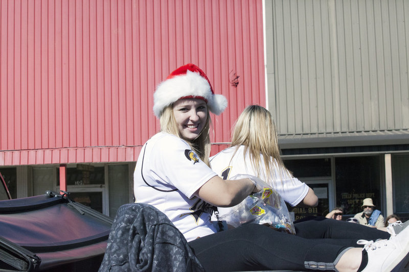 Image: Italy Lady Gladiator softball pitcher Jaclynn Lewis(15) and senior teammate Bailey Eubank(1) are among the most feared candy tossers along the parade route.