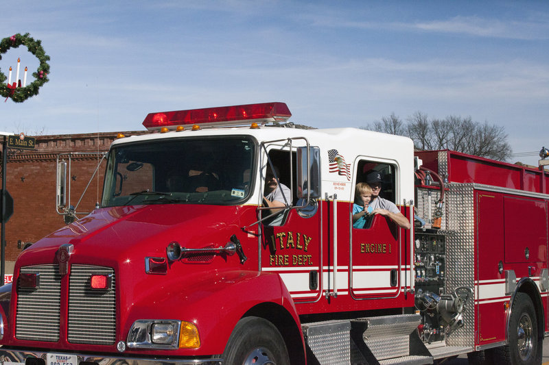 Image: The Italy Fire Department rolls thru for the holidays. If Santa has any problems Christmas Eve, the I.F.D. will get the famous gift giver up and going again.