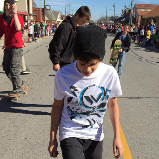 Image: Skaters With Attitude (S.W.A.) members Pablo, Brandon, Damon and Parker use their four-wheeled sleighs to maneuver down the Christmas parade route.