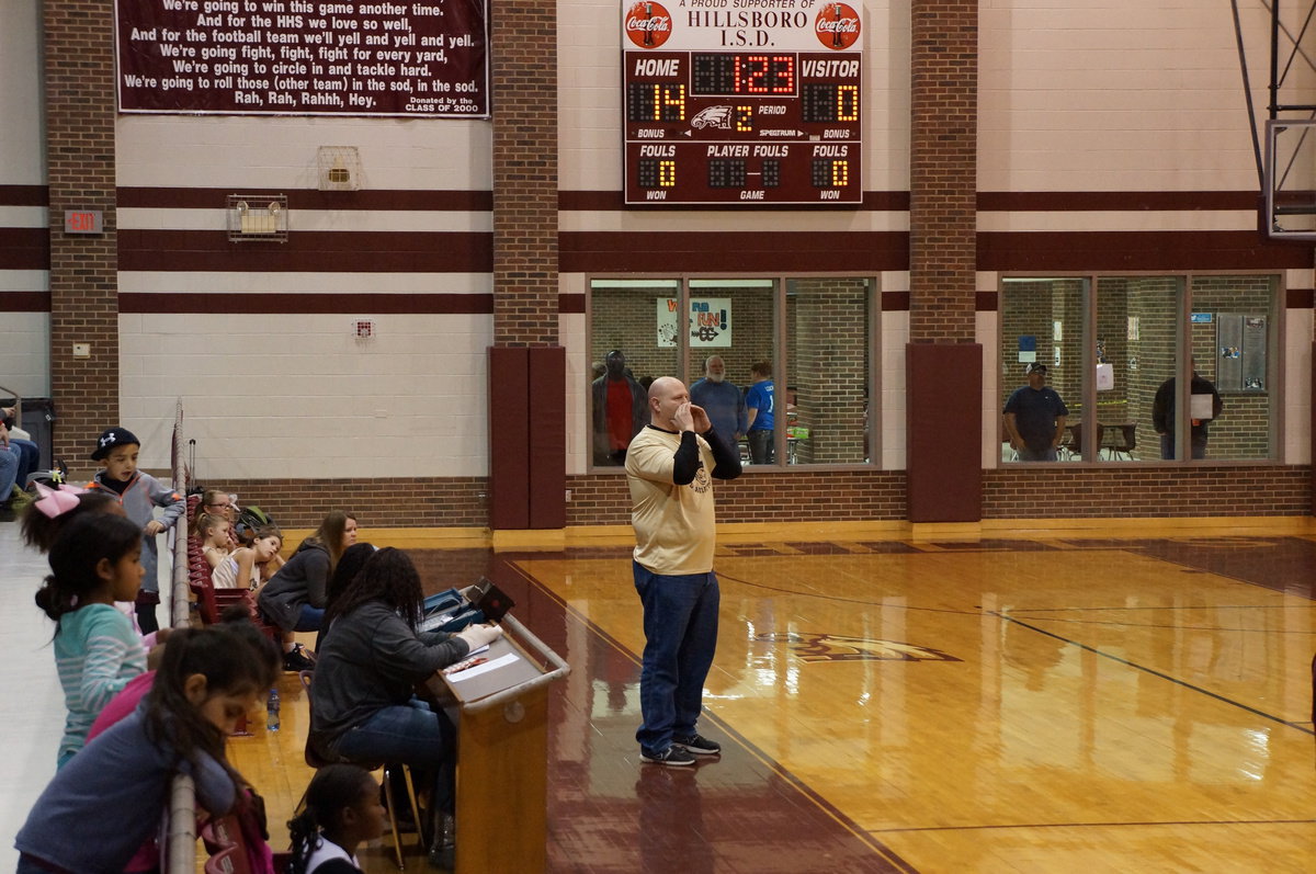 Image: Coach Haake helps get the girls lined up.