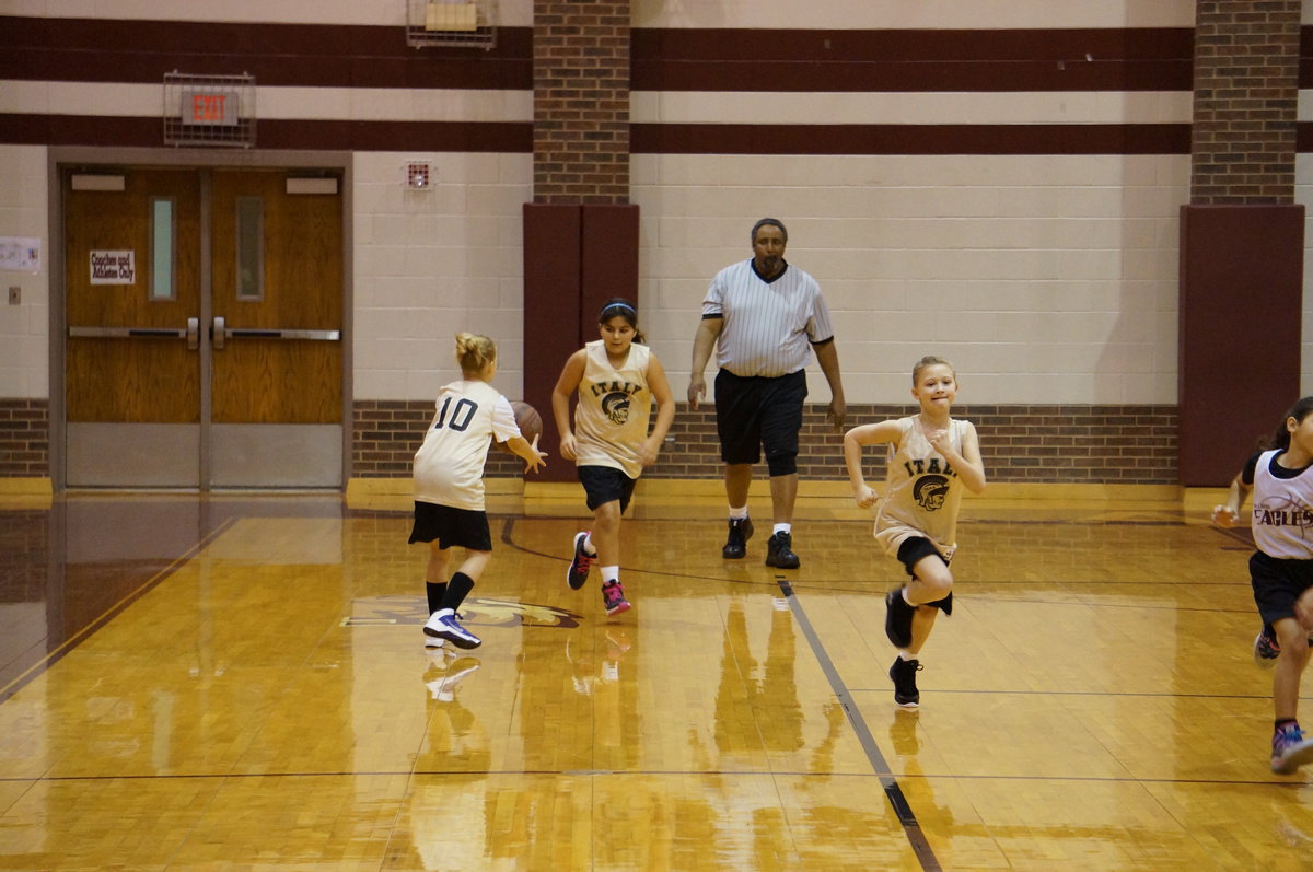 Image: Evie passes the ball to Kaylee for the next drive.