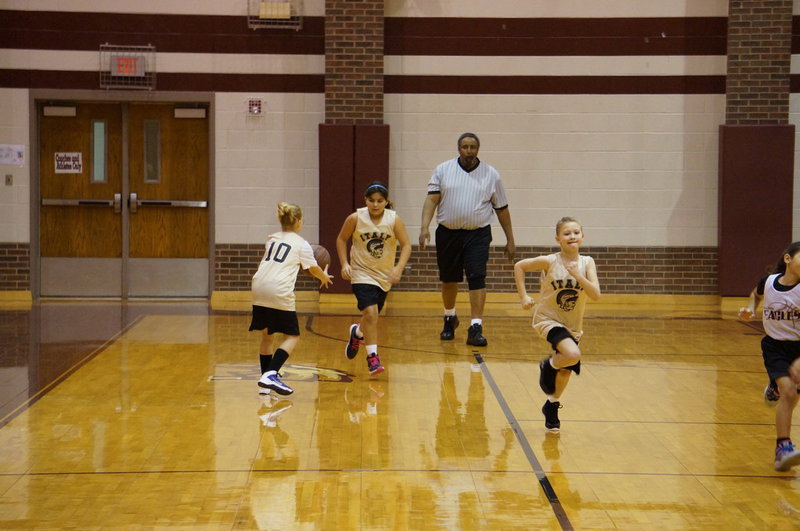 Image: Evie passes the ball to Kaylee for the next drive.