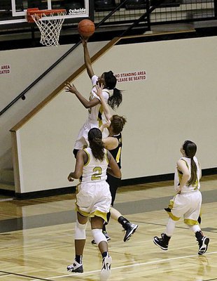 Image: Italy’s Kortnei Johnson(3) wins the race to the rim for 2-points with teammates Emmy Cunningham(2) and Tara Wallis(4) hustling down court to backup Johnson.