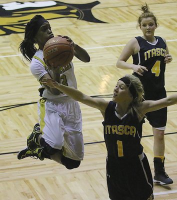 Image: Lady Gladiator Kortnei Johnson(3) floats to the basket with the greatest of ease.
