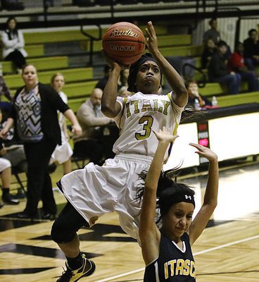 Image: Italy’s Kortnei Johnson(3) takes it strong to the rim for another 2-points.