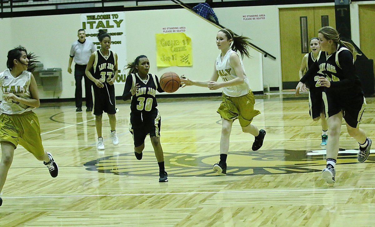 Image: Emily Guzman(15) fills the wing as teammate Lana Beets(11) tries to get her the ball.