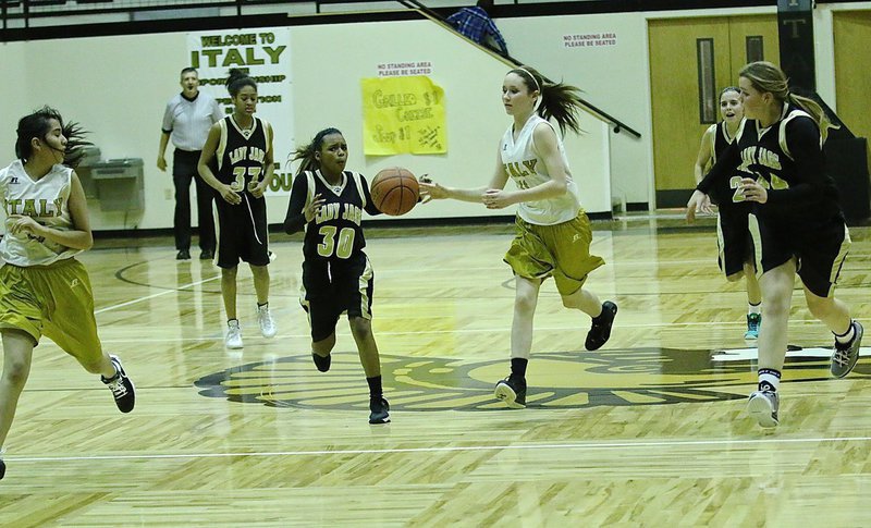 Image: Emily Guzman(15) fills the wing as teammate Lana Beets(11) tries to get her the ball.