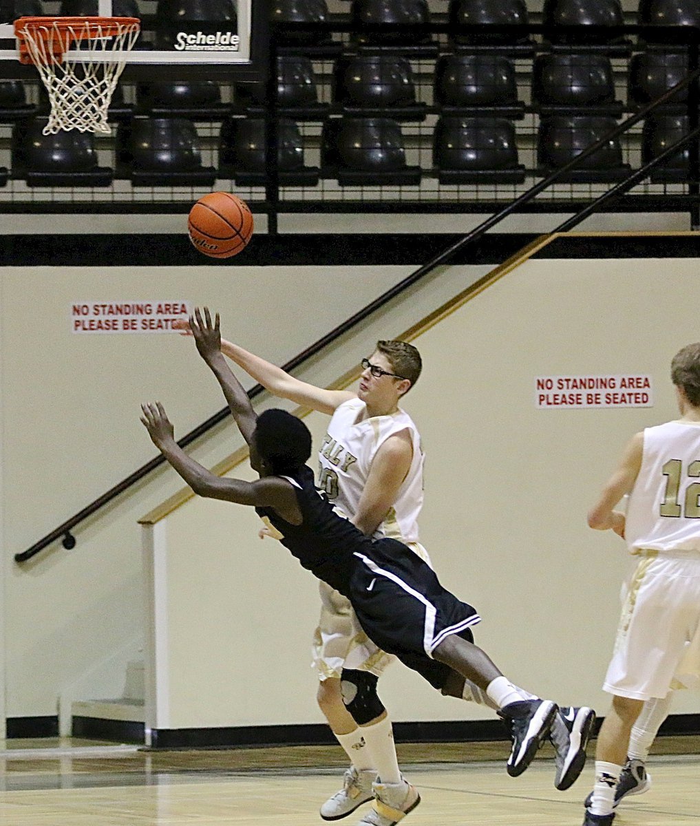 Image: JV Gladiator Michael Hughes(20) keeps a Dawson player from making a lucky shot.