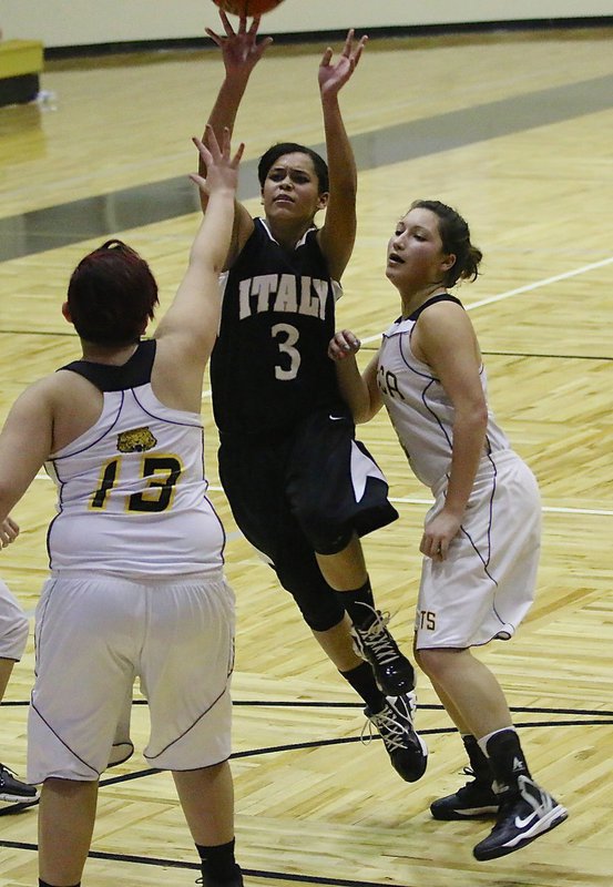 Image: Alex Minton-Felder(3) scores gets bumped while in the act of shooting to earn a trip to the line. Minton-Felder finished with 8-points to help lead the JV Lady Gladiators to a 27-21 win in the tournament championship game against Itasca during a tournament hosted in Italy this past weekend.