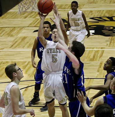 Image: JV Gladiator Dylan McCasland(5) takes a shot near the rim.