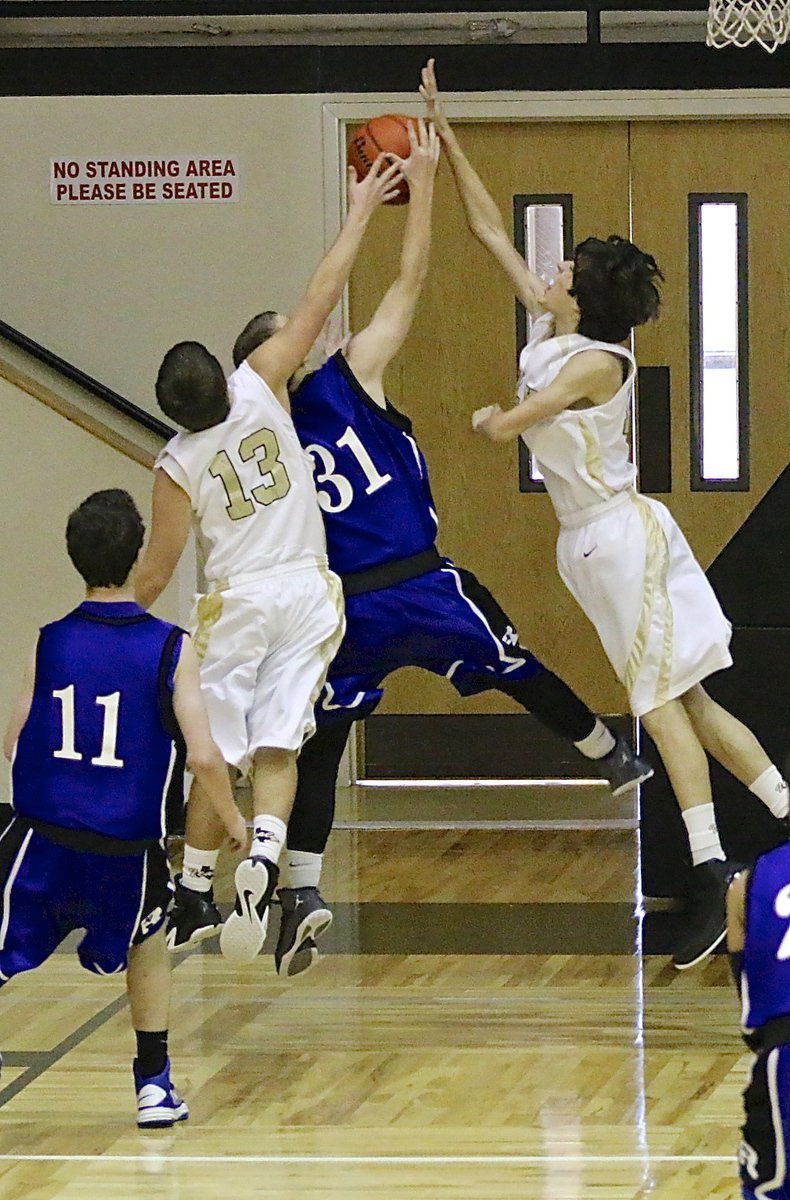 Image: JV Gladiators Cade Roberts(13) and Ty Hamiltonl(15) double-swat a Bulldog shot attempt.