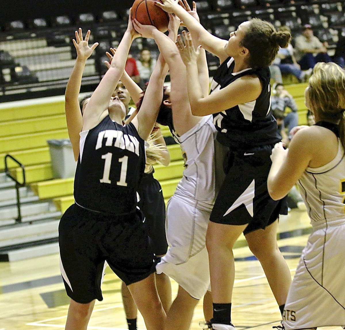 Image: Italy’s Annie Perry(11) and teammate Vanessa Cantu(24) battle for a rebound.