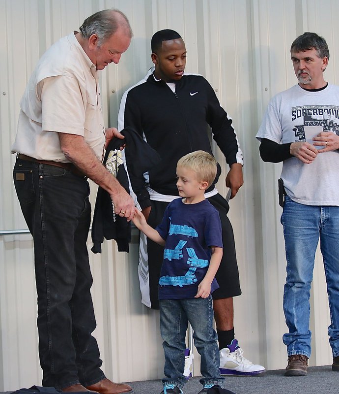 Image: IYAA C-team tight end Kace McDaniel shakes hands with Mayor James Hobbs before being handed his Superbowl Championship trophy. Kace would later comment, “I guess we really did win!”