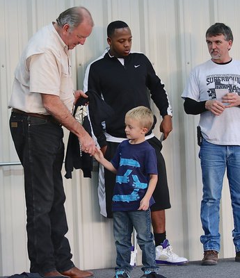 Image: IYAA C-team tight end Kace McDaniel shakes hands with Mayor James Hobbs before being handed his Superbowl Championship trophy. Kace would later comment, “I guess we really did win!”