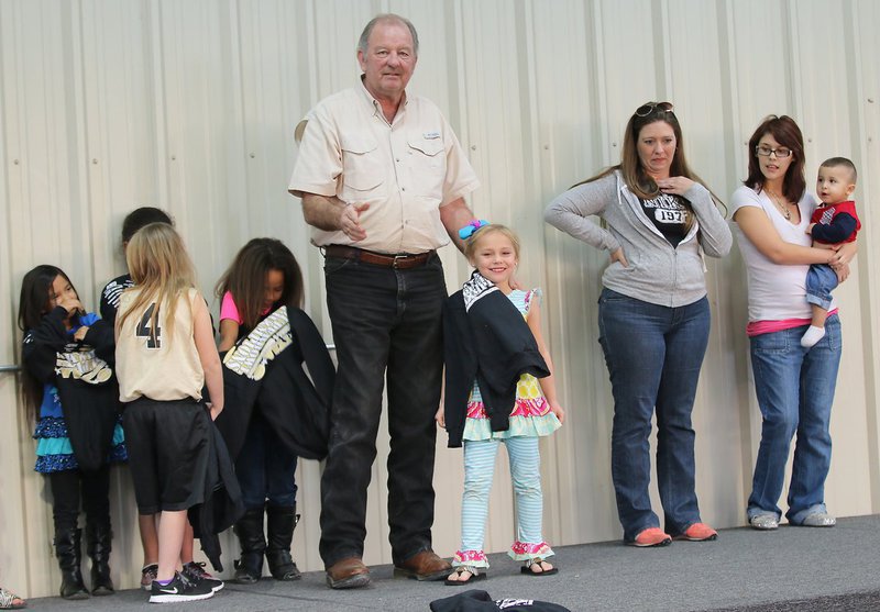 Image: City of Italy’s Mayor James Hobbs presents C-team cheerleader Charlea Padilla with her Superbowl Championship hoodie.