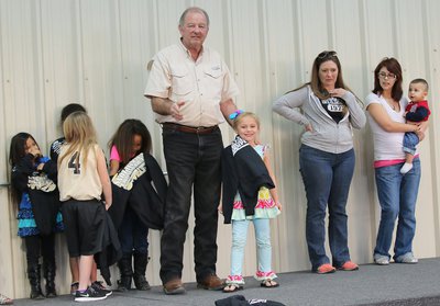 Image: City of Italy’s Mayor James Hobbs presents C-team cheerleader Charlea Padilla with her Superbowl Championship hoodie.
