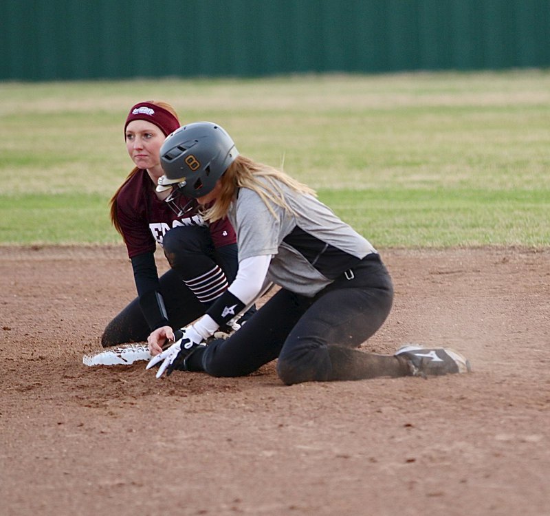 Image: Lady Gladiator Hannah Washington(8) slides safely into second-base to beat the throw.