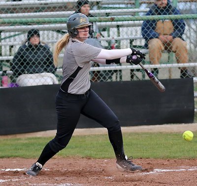 Image: Lady Gladiator Madison Washington(10) digs one out to hit in an RBI.