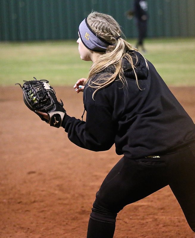 Image: Jaclynn Lewis(15) grabs an out after taking over at first-base.