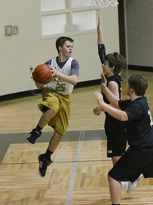 Image: Cason Roberts(25) tries to make an aerial pass thru two Dawson defenders.