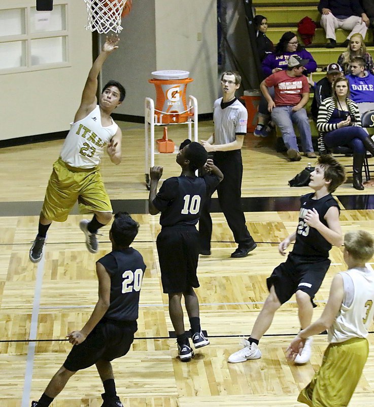 Image: Italy 8th Grader Aaron Franco(23) scores after a strong drive to the basket.