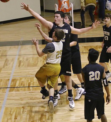 Image: Italy 8th grader Cason Roberts(25) gets a tough shot up and over Dawson’s big man.