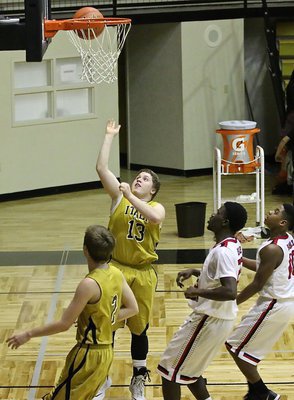 Image: Gladiator John Escamilla(13) makes the toughest shot in basketball, a wide-open layup.