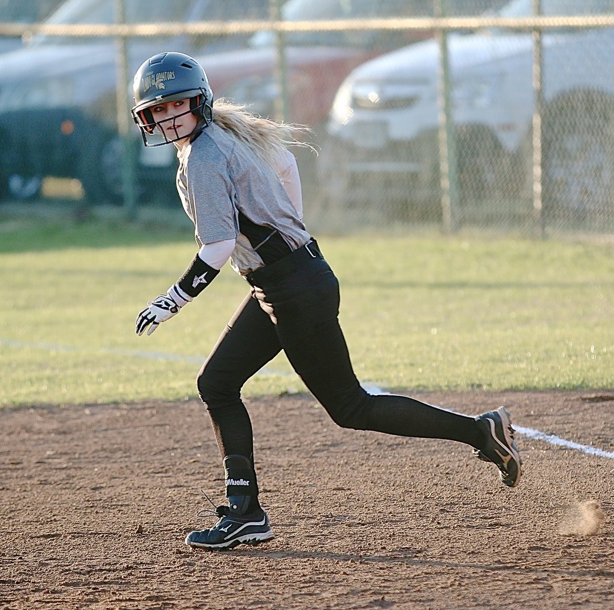 Image: Britney Chambers(4) hits a single and then charges to second-base for Italy.