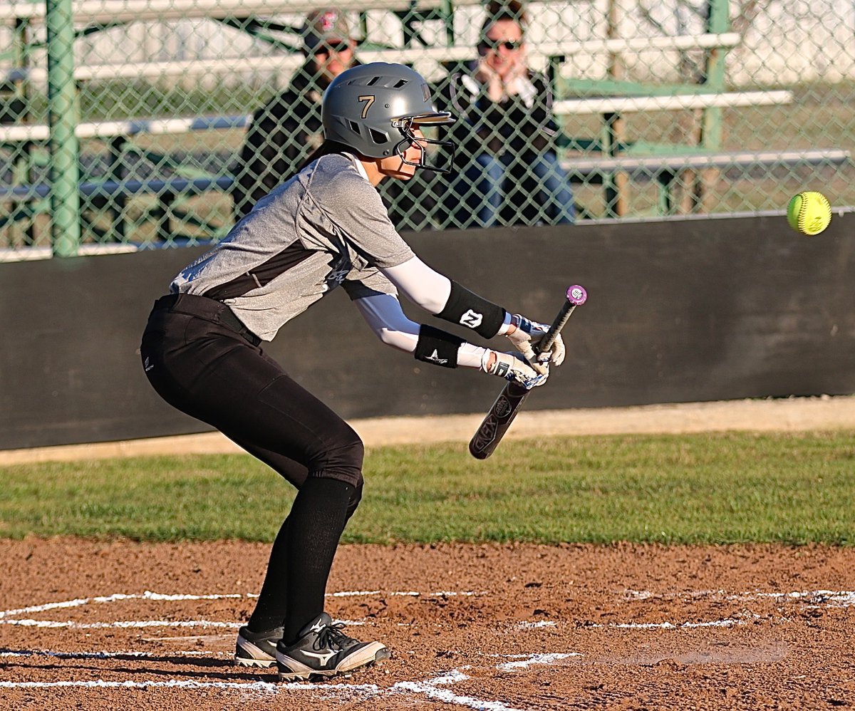 Image: Lady Gladiator April Lusk(7) taps a bunt and then outruns the throw to first-base.
