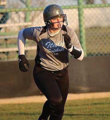 Image: Making her trek around the bases is Madison Washington(10) as Red Oak Life scrambles to relay the ball in.