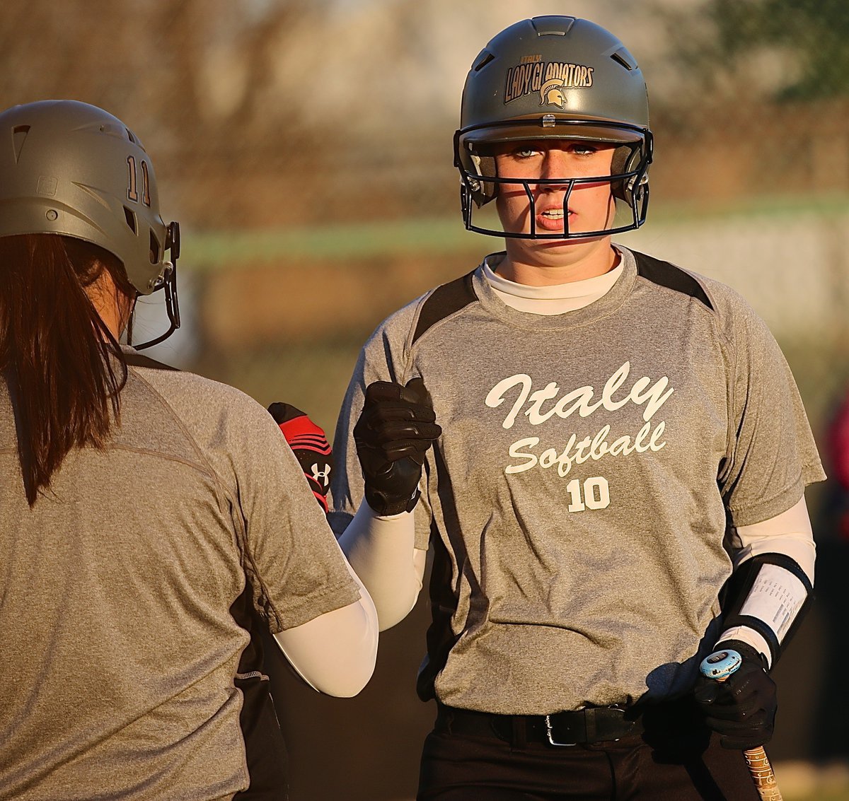 Image: Madison Washington(10) is congratulated by Jenna Holden after Washington pulled off an inside-the-park homerun.