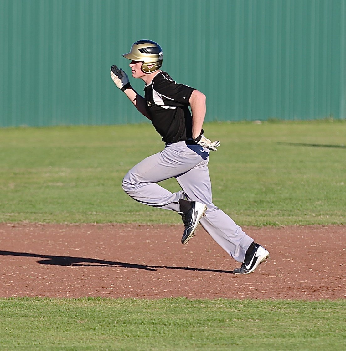 Image: Clay Riddle strides it out for a triple against Avalon.
